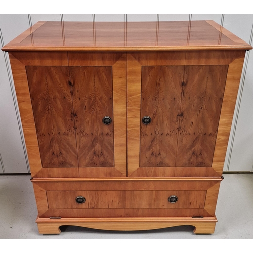9 - A good quality, inlaid yew TV cabinet. Features concertina doors, over fall storage area, with a ret... 