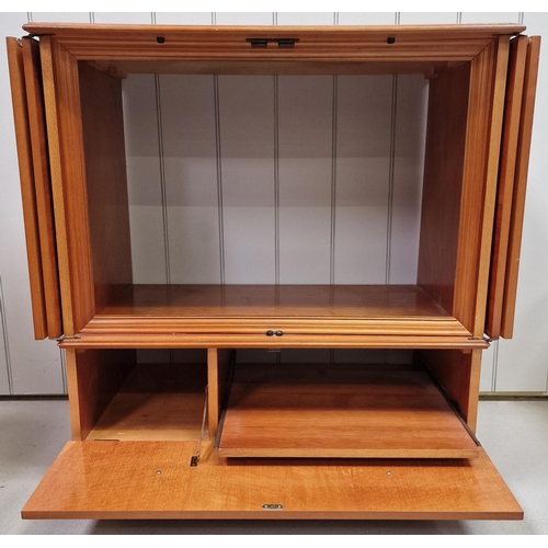 9 - A good quality, inlaid yew TV cabinet. Features concertina doors, over fall storage area, with a ret... 