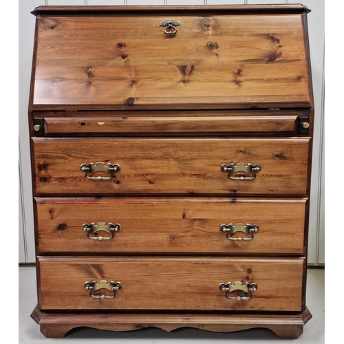 10 - A vintage, solid pine bureau. Features fall front desk area, over three drawers, with brass handles.... 