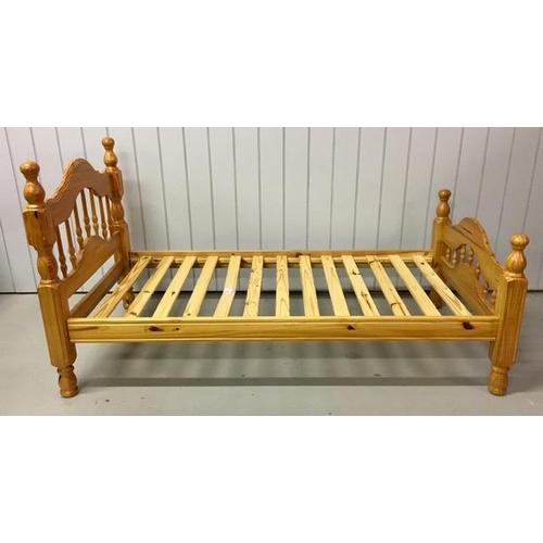 13 - A solid pine single bed frame, with slatted base. Largest dimensions(cm) H107, W103, L207.