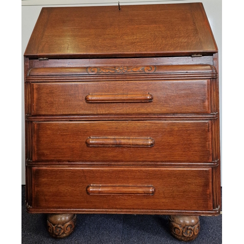 14 - An Edwardian period, oak bureau. Drop-front, partially fitted interior over three graduated drawers.... 