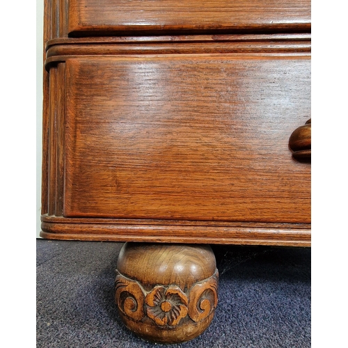 14 - An Edwardian period, oak bureau. Drop-front, partially fitted interior over three graduated drawers.... 