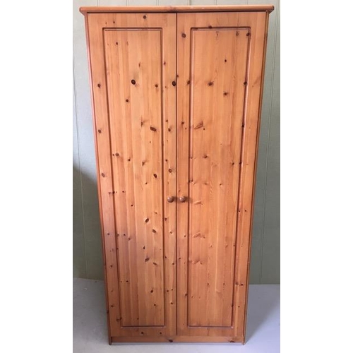 22 - A pine double wardrobe, with single interior shelf & hanging rail. Dimensions(cm) H187, W83, D57.
