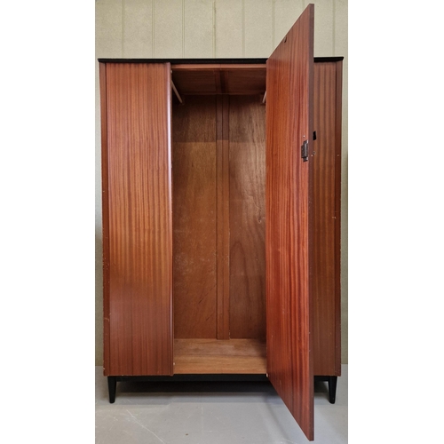 23 - A mid-century double wardrobe, with single door, on typical, raised platform legs. Dimensions(cm) H1... 