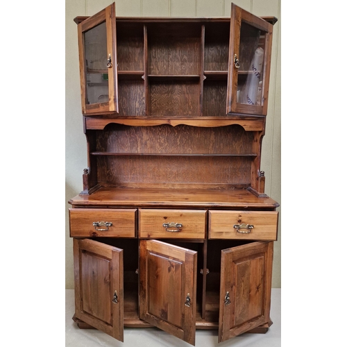 24 - A good quality, dark stained pine dresser, with brass fittings. Dimensions(cm) H191, W125, D43.