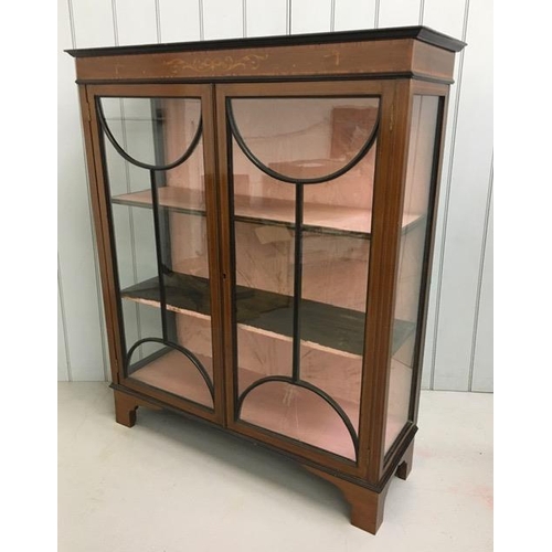 36 - An Edwardian, inlaid mahogany, glazed bookcase with two internal shelves. No key present & one pane ... 