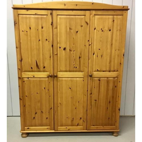 37 - A pine triple wardrobe. Incorporates double & single hanging rails, single shelf throughout & is sup... 