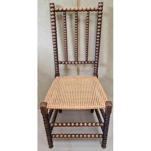 43 - A 19th century walnut Bobbin chair, with woven cane seat. Dimensions(cm) H105(47 to seat), W48, D48.