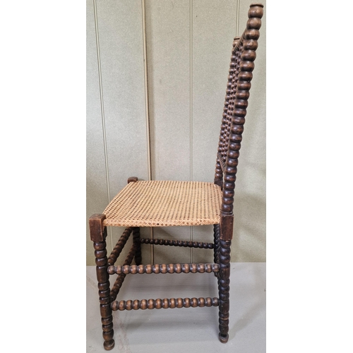 43 - A 19th century walnut Bobbin chair, with woven cane seat. Dimensions(cm) H105(47 to seat), W48, D48.