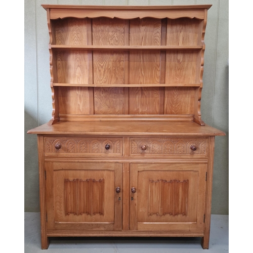 49 - A light oak, Arts & Crafts Welsh Dresser. Two plate shelves, over twin carved-front drawers, over do... 