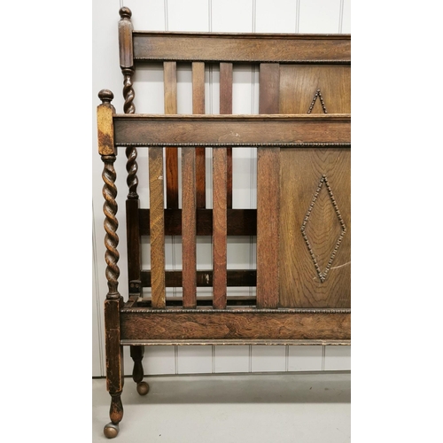 55 - An Edwardian oak bed frame. To include headboard, footboard & irons. Headboard 140cm x 138cm; footbo... 