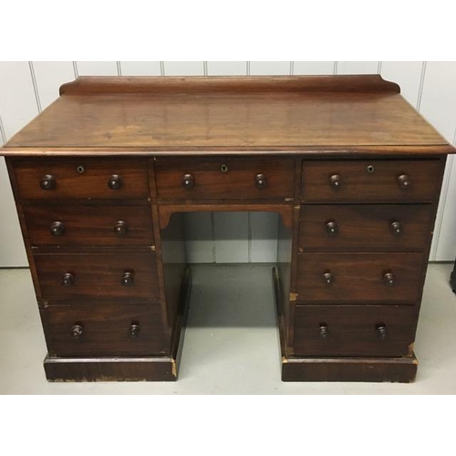 57 - A vintage, mahogany kneehole desk, with two banks of four graduated drawers & a single central drawe... 