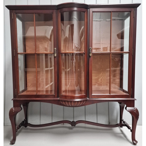 66 - A bow-front display cabinet, with two interior glass shelves. Dimensions(cm) H134, W122, D42.