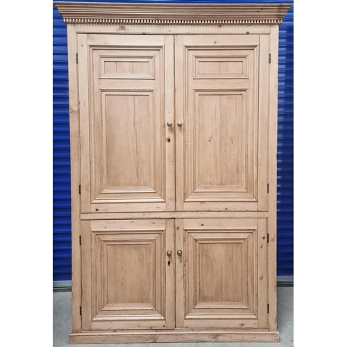 95 - A substantial Victorian stripped pine linen cupboard,  with panelled doors & shelved interior. Dimen... 