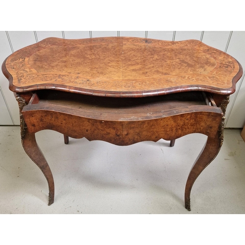 112 - A burr walnut French writing table, with brass mounts & single drawer. Dimensions(cm) H75, W99, D55.