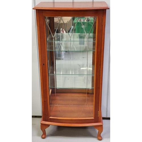 119 - A yew-veneered narrow display cabinet, with two interior glass shelves. Currently locked, without ke... 
