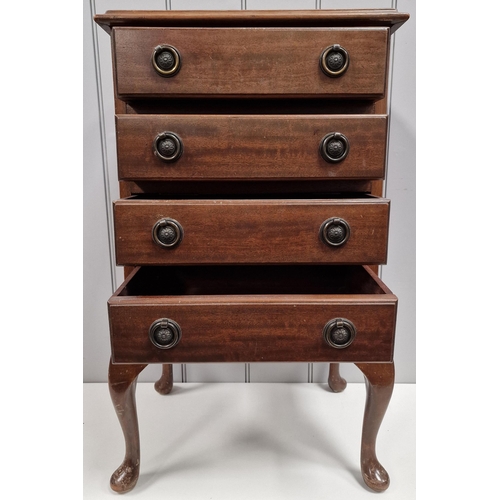 123 - A mahogany bedside chest of drawers or music cabinet, with inset leather top & four drawers, raised ... 