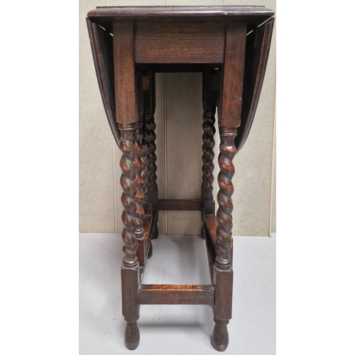 127 - An Edwardian oak, gateleg table with barley twist legs. Dimensions(cm) H72, W32/91, D62.