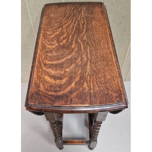 127 - An Edwardian oak, gateleg table with barley twist legs. Dimensions(cm) H72, W32/91, D62.