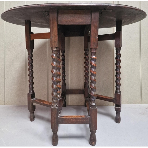 127 - An Edwardian oak, gateleg table with barley twist legs. Dimensions(cm) H72, W32/91, D62.