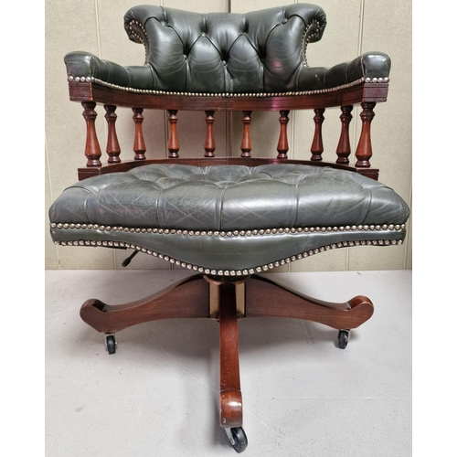 133 - A stunning mahogany & green leather button seat/backed, swivel Captain's chair, on castors. Dimensio... 