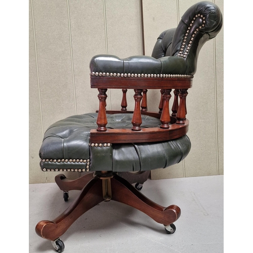 133 - A stunning mahogany & green leather button seat/backed, swivel Captain's chair, on castors. Dimensio... 