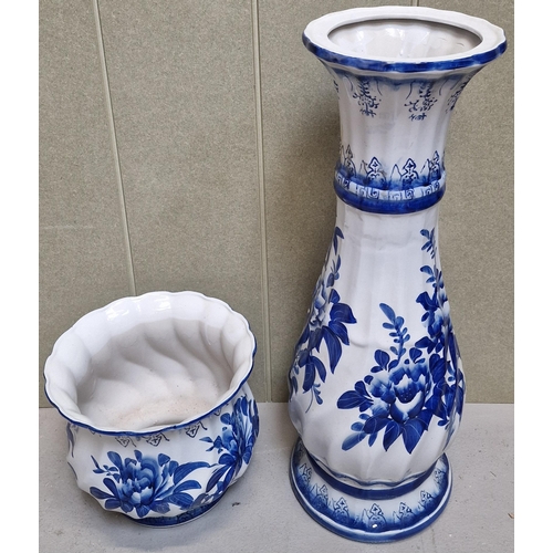 160 - A Delft-style blue & white jardiniere & stand. Dimensions(cm) H90, W28, D28.