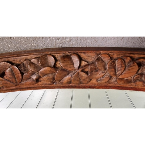 161 - A vintage, oak-framed overmantle mirror, with a carved leaf design. Dimensions 55cm x 82cm.