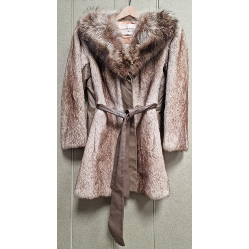 215 - A vintage, mid-length fur coat by 'The Bon Marche Fur Salon'.