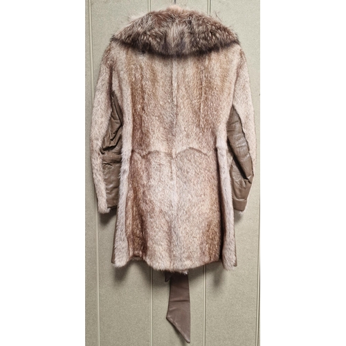 215 - A vintage, mid-length fur coat by 'The Bon Marche Fur Salon'.