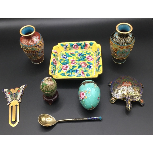 291 - A collection of eight cloisonne pieces. To include vases, eggs, trinket dish, tortoise figure, bookm... 