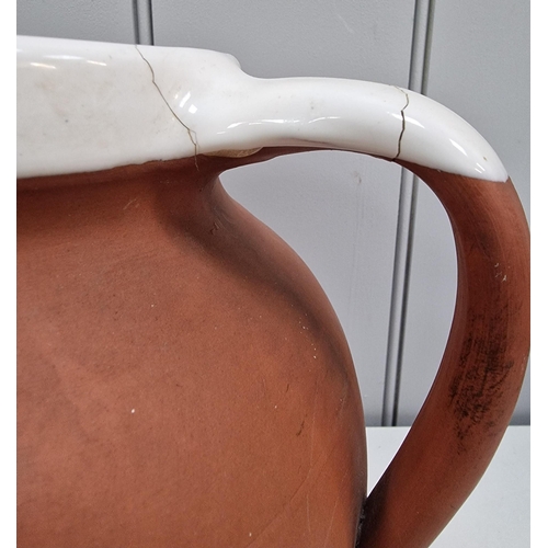 304 - A Royal Barum Ware large terracotta water jug, together with a vintage, two-piece imported wash set.