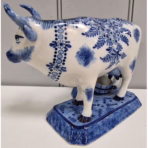 305 - A 19th century Dutch Delft Maid Milking Cow figure. Dimensions(cm) H17.5, L21.5, D14.