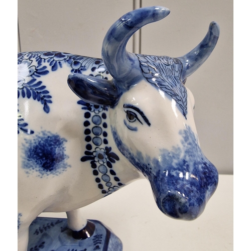 305 - A 19th century Dutch Delft Maid Milking Cow figure. Dimensions(cm) H17.5, L21.5, D14.