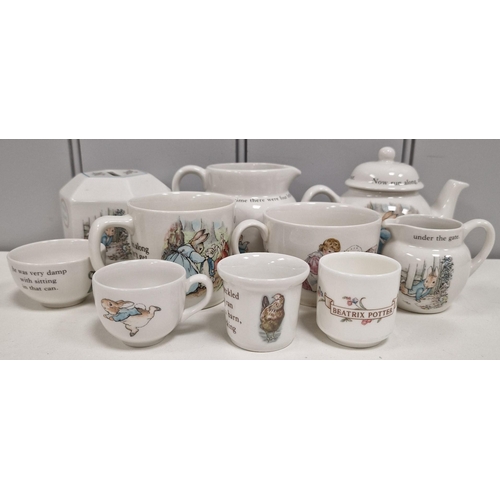 336 - A collection of twenty-six branded Beatrix Potter items. To include boxed Wedgwood examples, moneybo... 