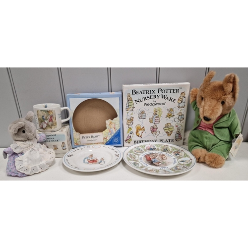 336 - A collection of twenty-six branded Beatrix Potter items. To include boxed Wedgwood examples, moneybo... 