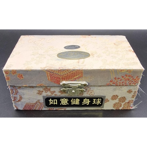 395 - A boxed set of Chinese Baoding Balls.