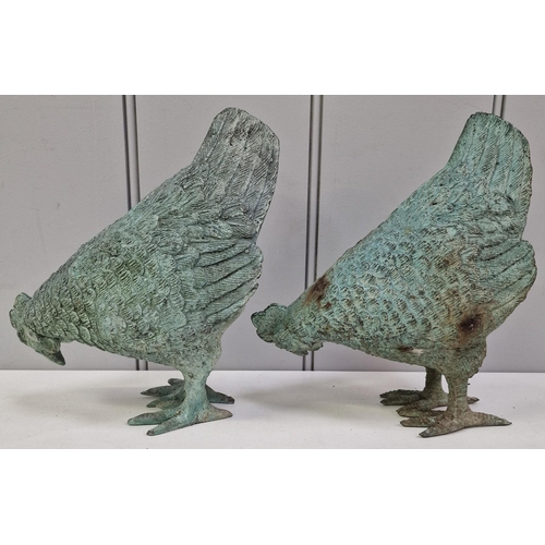 422 - A pair of cast metal garden roosters. Dimensions(cm) H21, W18, D9.