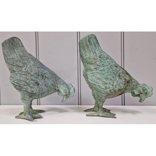 422 - A pair of cast metal garden roosters. Dimensions(cm) H21, W18, D9.