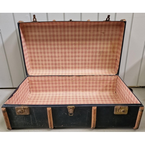 462 - A large, wood bound traveller's trunk. No keys. Dimensions(cm) H33, W90, D52.