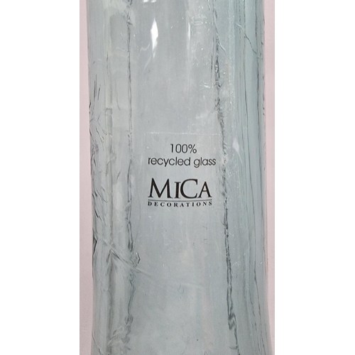 556 - A tall, decorative bottle vase, by 'MICA Decorations', made from recycled glass. Height 101cm, diame... 