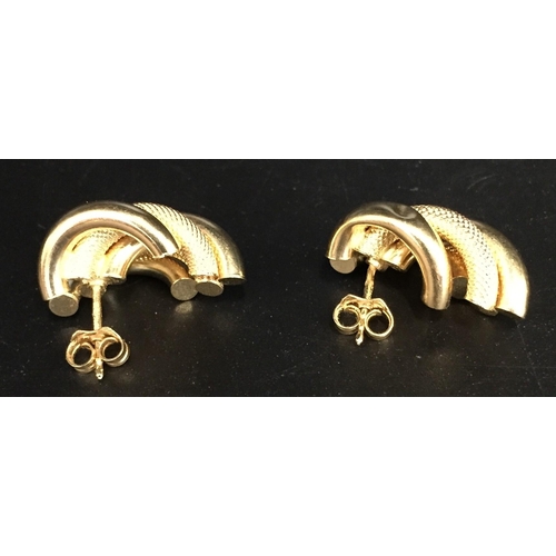 649 - A hallmarked 18ct gold, interlocking hoop/alternating pattern design, pair of earrings. Weight appro... 