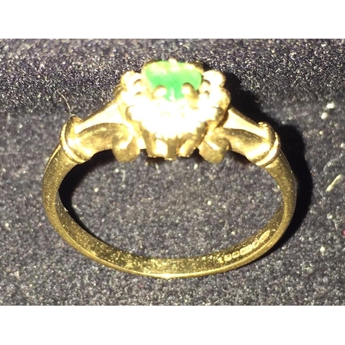 663 - A 9ct gold emerald & diamond set cluster ring. Size M. Weight approx. 2.1g