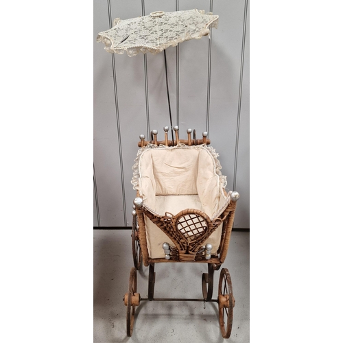 745 - A vintage, Victorian-style wicker & iron doll's pram, with parasol. Overall dimensions with parasol(... 