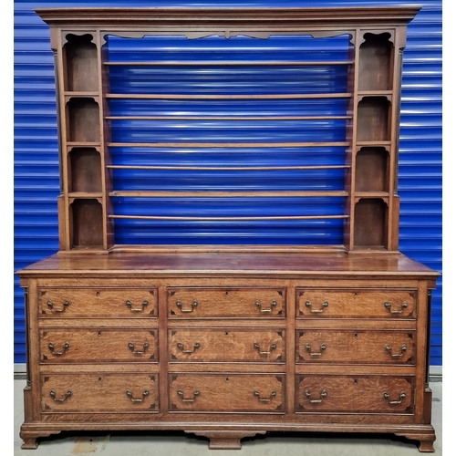 A substantial Georgian open dresser. Plate shelves flanked by display compartments, over a triple drawer appearance base (six drawers & a dummy-front cupboard). Dimensions(cm) H220, W200, D57.
