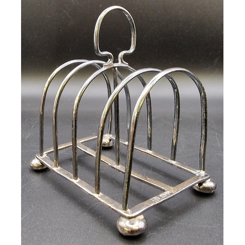 621 - A hallmarked silver toast rack (Chester, by George Nathan & Ridley Hayes), together with a hallmarke... 