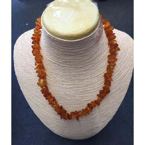 665 - A rough tumbled amber necklace. Approx. 50cm.