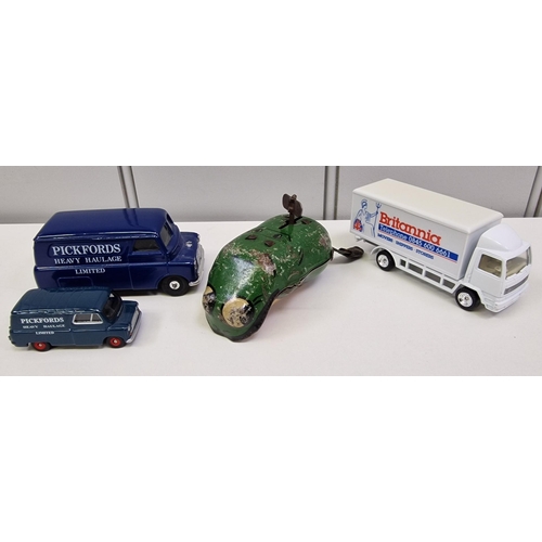 738 - A tinplate clockwork frog, together with three diecast vehicles.