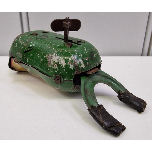 738 - A tinplate clockwork frog, together with three diecast vehicles.