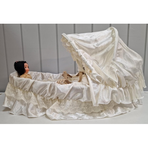 741 - A vintage doll & bassinet.